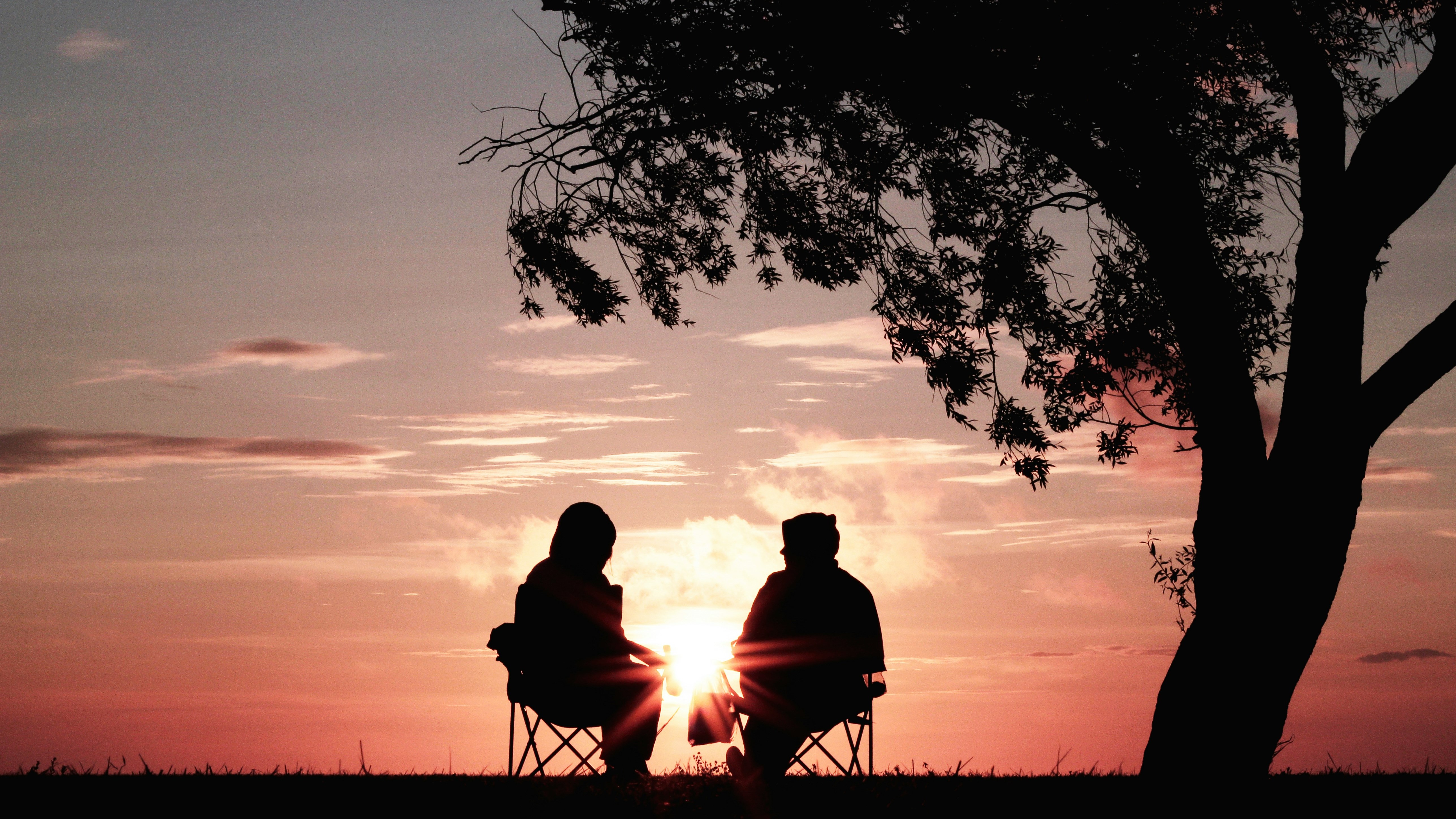 couple sitting watching a sunset